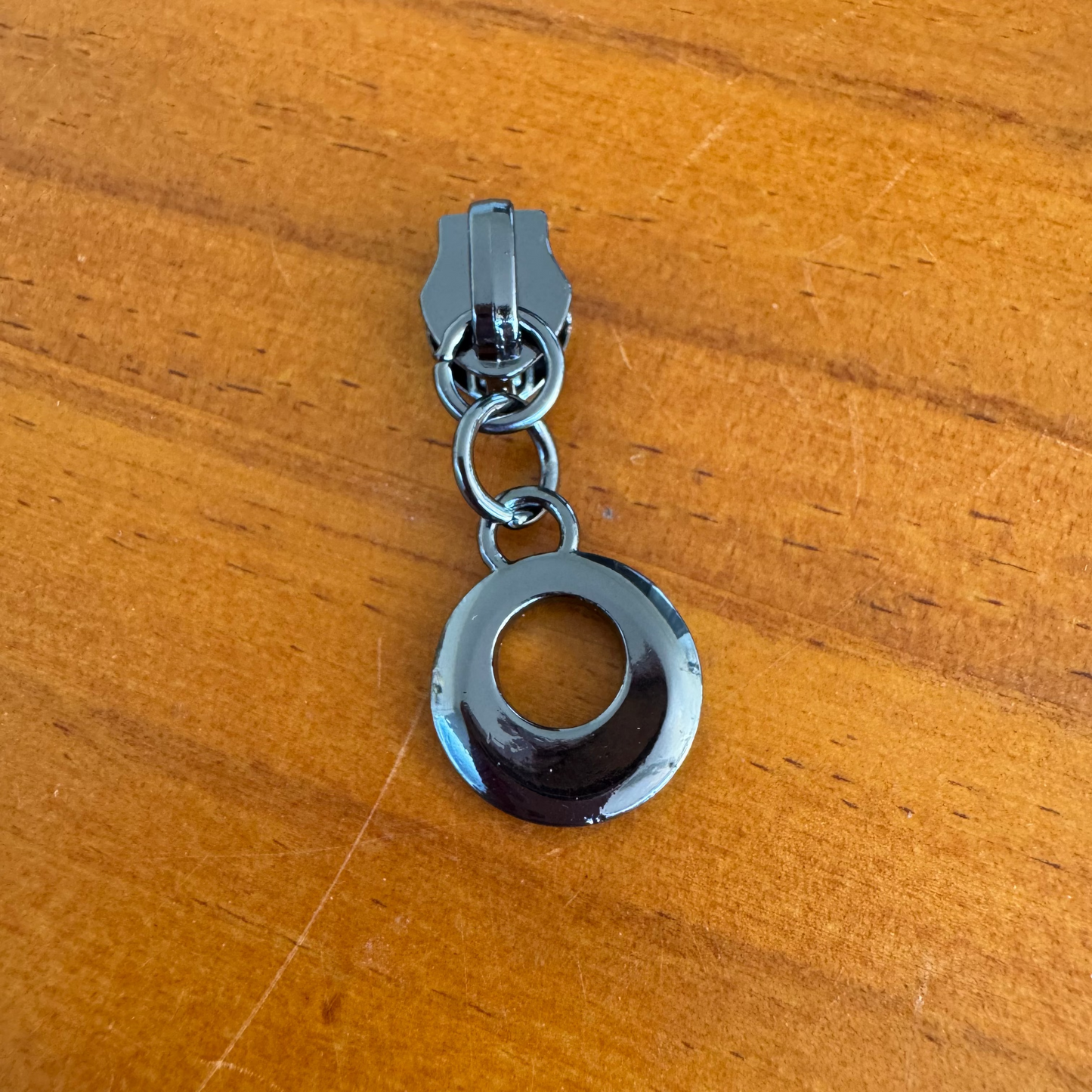 Bag making zipper pulls circular gunmetal